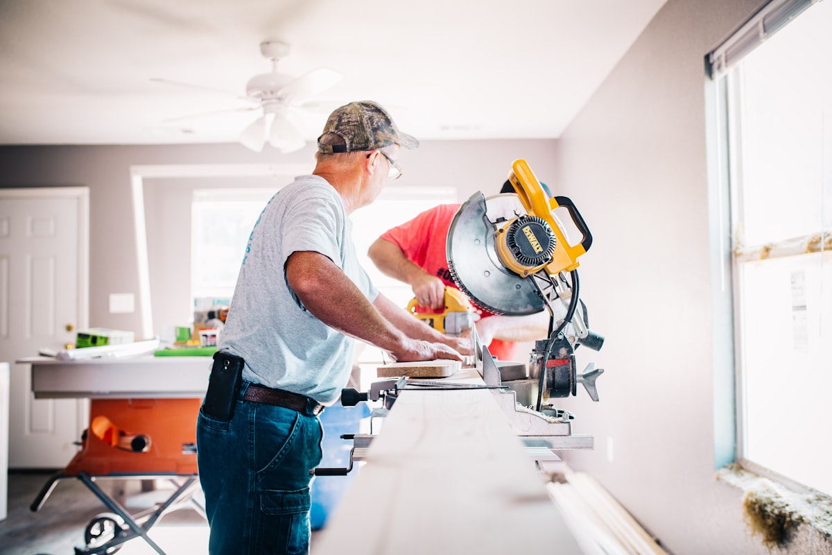 Toy Handyman Services technicians cutting trim with a miter saw during a home renovation project
